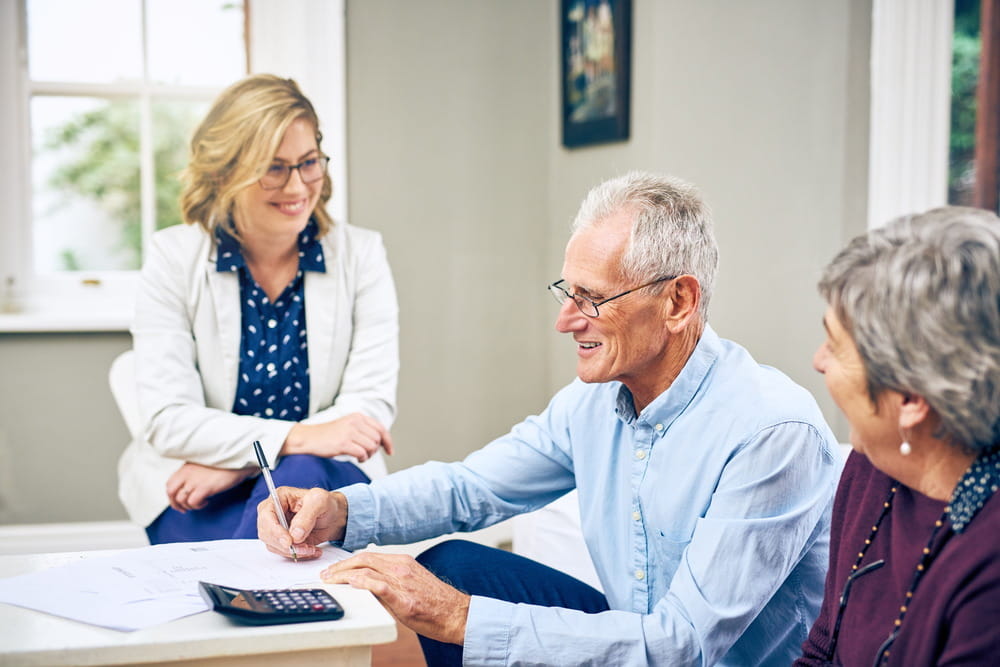 Divorce mediator reviewing financial documents with clients during Colorado divorce mediation